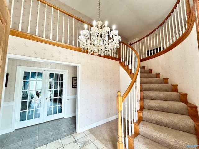 stairway featuring an inviting chandelier, french doors, tile patterned floors, and a towering ceiling