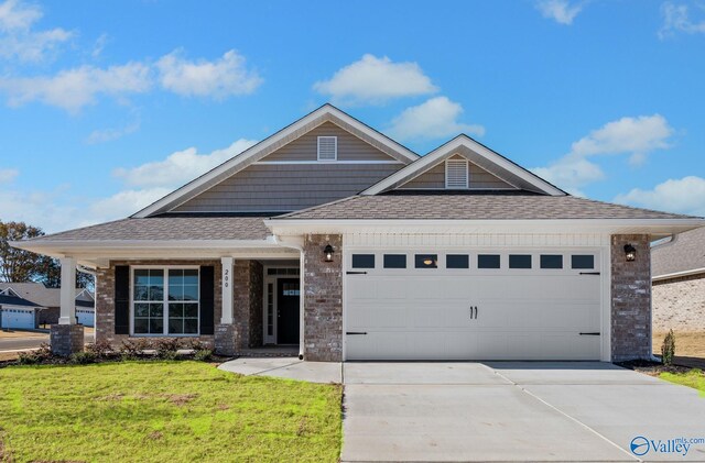 view of front of home featuring a garage and a front yard