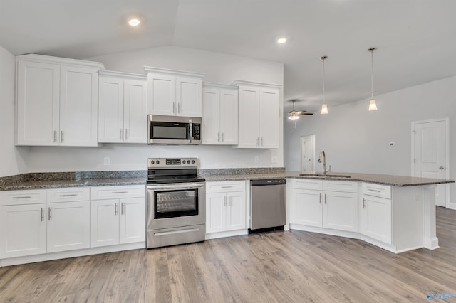 kitchen featuring pendant lighting, stainless steel appliances, white cabinetry, and sink