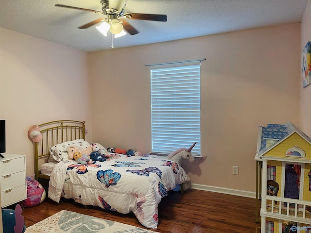 bedroom with dark hardwood / wood-style floors and ceiling fan