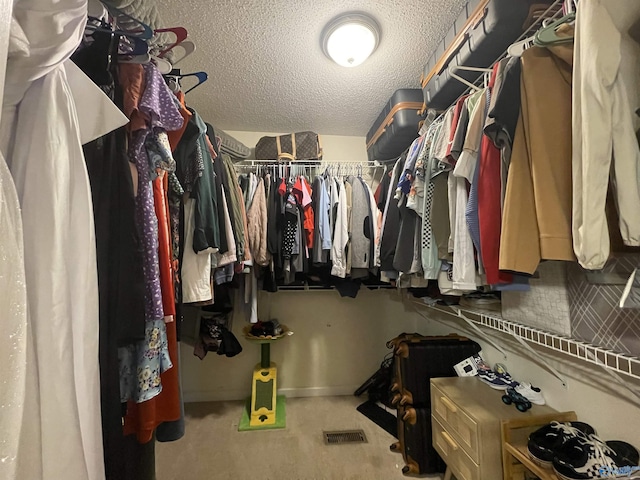 walk in closet featuring carpet