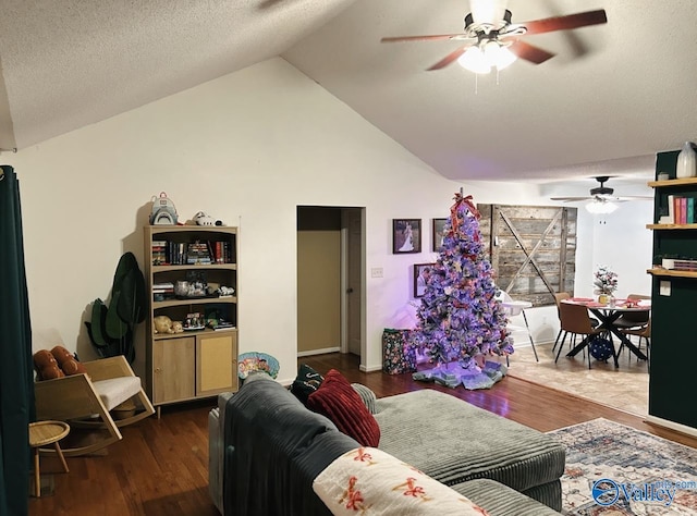 living room featuring ceiling fan, dark hardwood / wood-style floors, and lofted ceiling