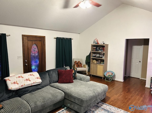 living room with dark hardwood / wood-style floors, ceiling fan, and vaulted ceiling