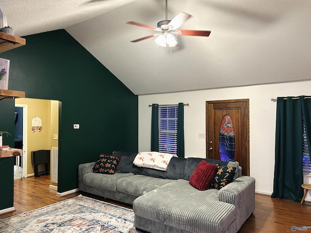 living room with hardwood / wood-style floors, ceiling fan, lofted ceiling, and a textured ceiling