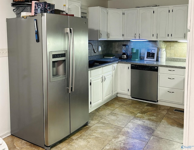 kitchen featuring backsplash, sink, white cabinets, and appliances with stainless steel finishes