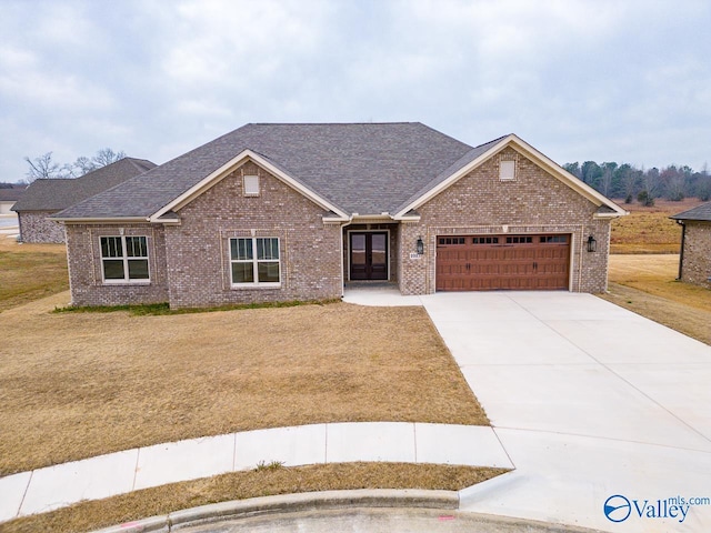 view of front facade with a garage and a front lawn