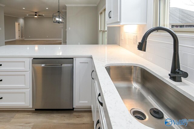 kitchen featuring white cabinets, sink, backsplash, light hardwood / wood-style floors, and dishwasher