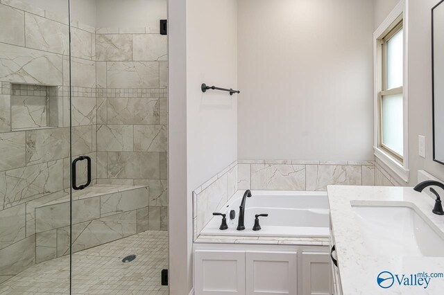 bathroom with sink, shower with separate bathtub, and a healthy amount of sunlight