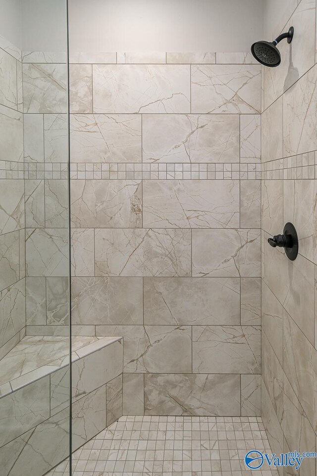 bathroom with a tile shower