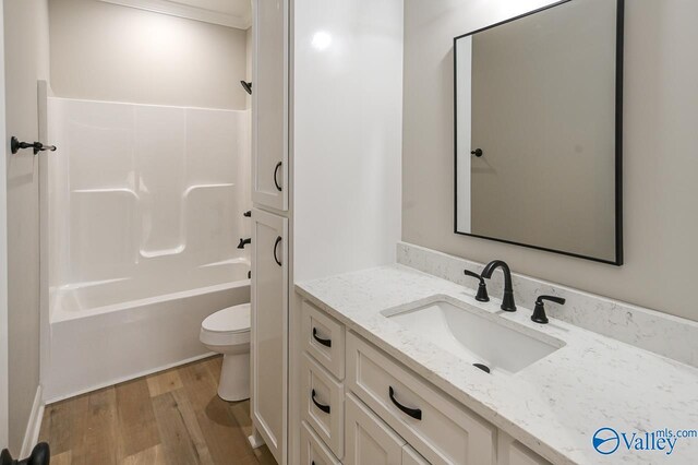 full bathroom featuring vanity, shower / bathing tub combination, toilet, and hardwood / wood-style floors