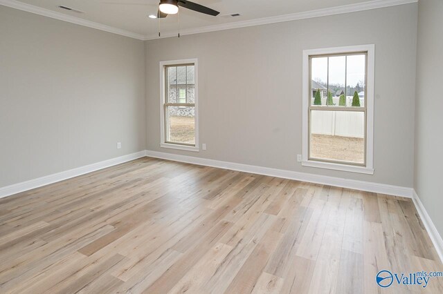 spare room featuring light hardwood / wood-style floors, ceiling fan, and crown molding