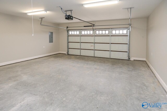 garage with a garage door opener and electric panel