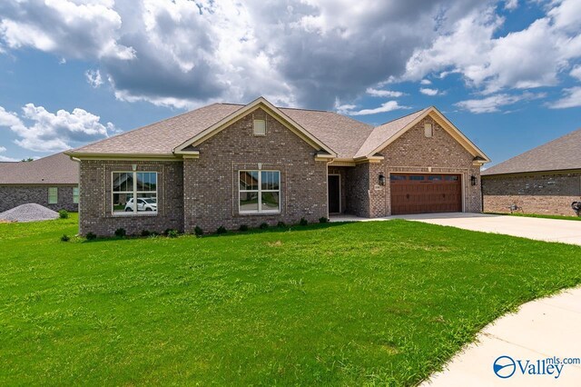 view of front of house featuring a garage and a front lawn