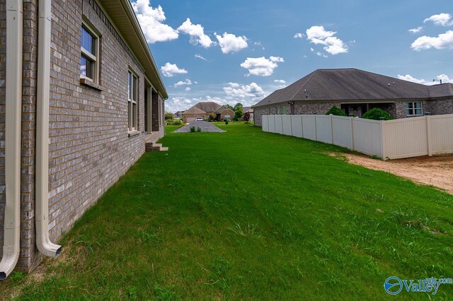 back of property featuring a lawn