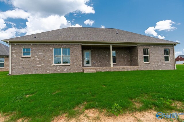 view of front of house with a garage and a front lawn