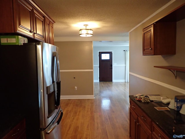 724 Frost St SW, Hartselle, AL 35640 - kitchen featuring stainless steel fridge, light wood-type flooring, dark countertops, a textured ceiling, and crown molding