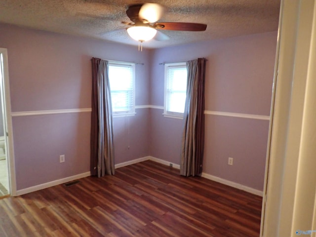 724 Frost St SW, Hartselle, AL 35640 - empty room with dark wood finished floors, ceiling fan, and a textured ceiling