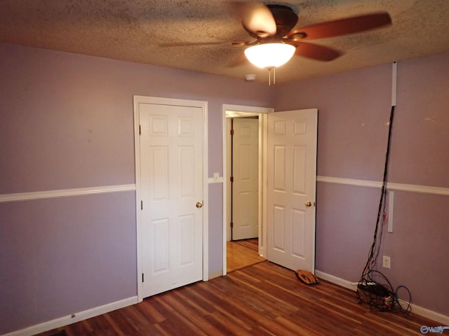 724 Frost St SW, Hartselle, AL 35640 - unfurnished bedroom with wood finished floors, a textured ceiling, and a ceiling fan
