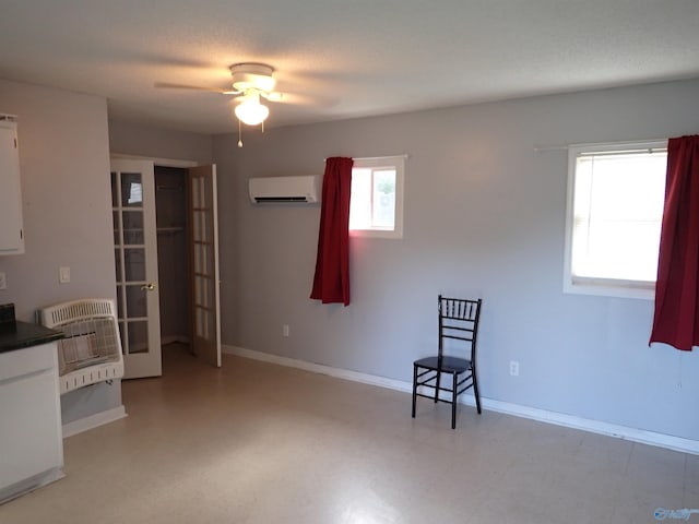 724 Frost St SW, Hartselle, AL 35640 - unfurnished room featuring a wall mounted air conditioner, heating unit, french doors, ceiling fan, and light floors
