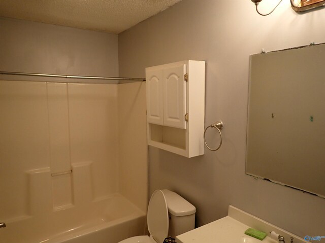 724 Frost St SW, Hartselle, AL 35640 - bathroom featuring a textured ceiling, vanity, and shower / tub combination