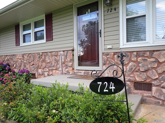 724 Frost St SW, Hartselle, AL 35640 - view of exterior entry featuring covered porch and stone siding
