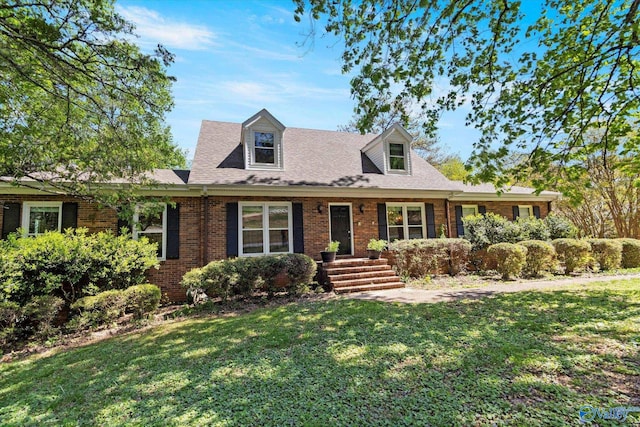 cape cod home with a front lawn