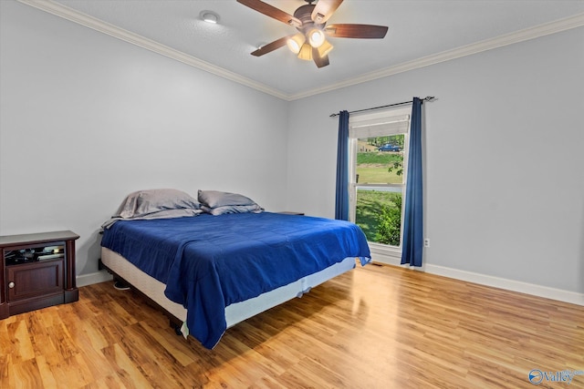 bedroom with crown molding, hardwood / wood-style floors, and ceiling fan