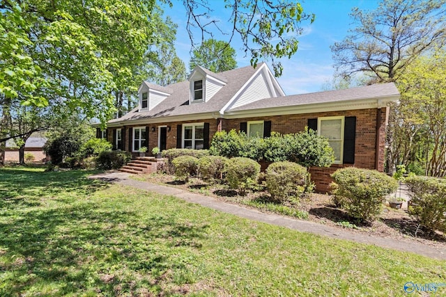 cape cod house with a front lawn and covered porch