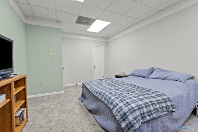 carpeted bedroom with a paneled ceiling