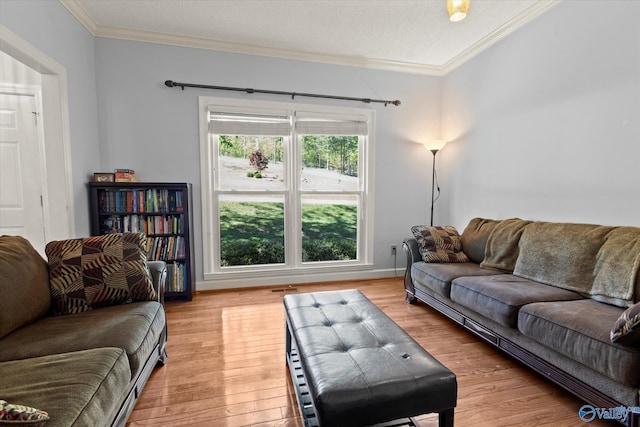 living room featuring ornamental molding, a textured ceiling, and hardwood / wood-style floors