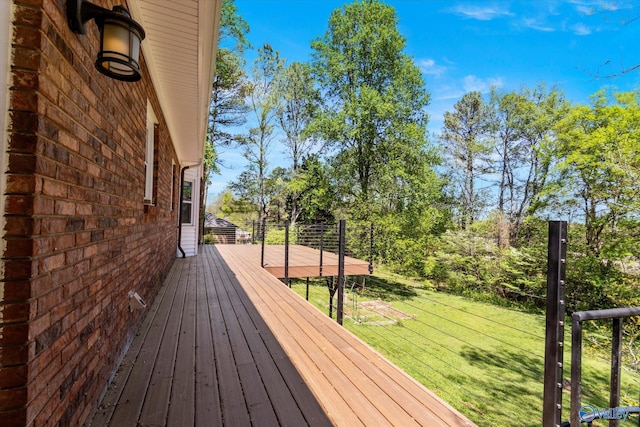 wooden terrace with a lawn