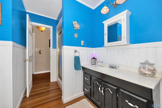 16904 Linton Rd, Athens, AL 35613 - bathroom featuring wainscoting, ornamental molding, vanity, wood finished floors, and a decorative wall