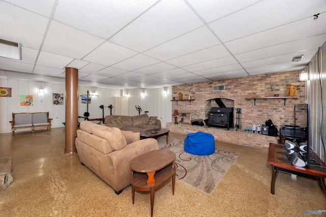 16904 Linton Rd, Athens, AL 35613 - living room featuring a wood stove, a drop ceiling, and brick wall