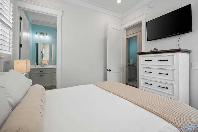 bedroom featuring ornamental molding, recessed lighting, and ensuite bath