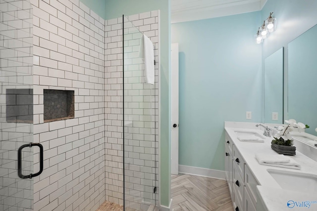 bathroom with double vanity, a stall shower, and a sink