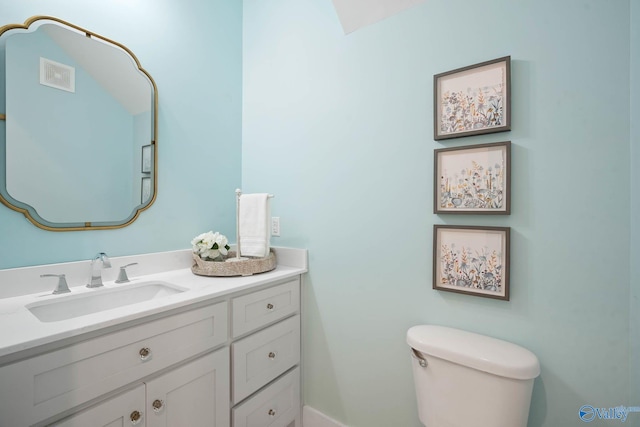 bathroom featuring visible vents, vanity, and toilet