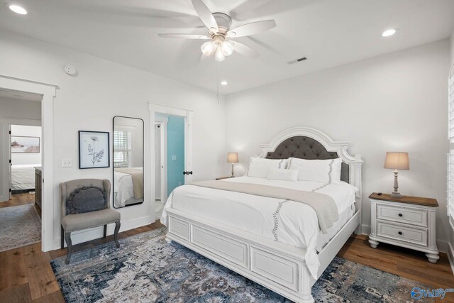 bedroom featuring baseboards, visible vents, wood finished floors, and recessed lighting