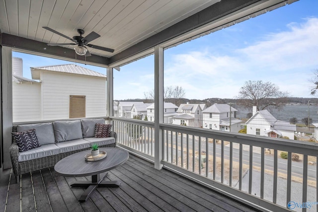 wooden deck featuring an outdoor hangout area, a residential view, and a ceiling fan