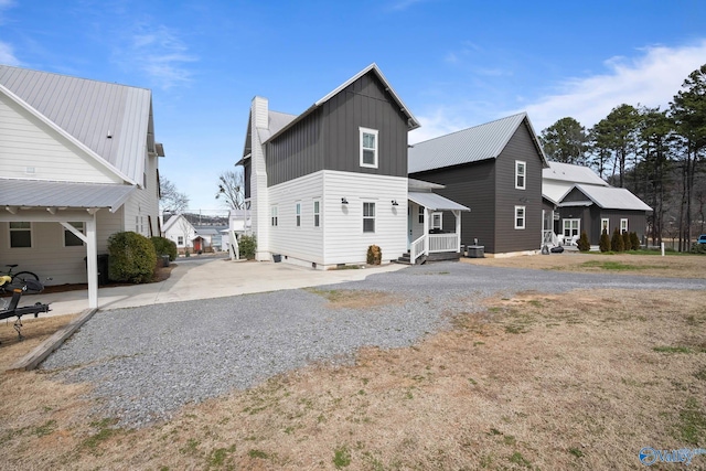 exterior space with board and batten siding and driveway