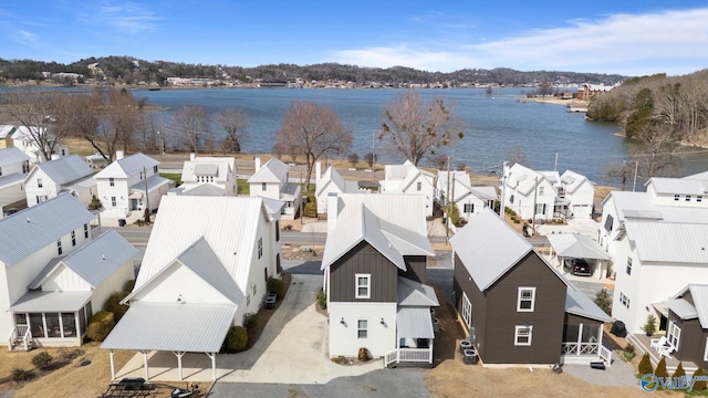 birds eye view of property with a residential view and a water view