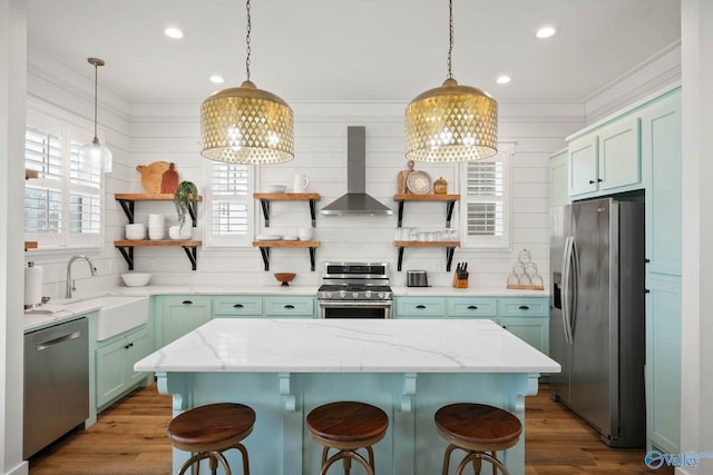 kitchen featuring open shelves, wall chimney range hood, stainless steel appliances, and a sink