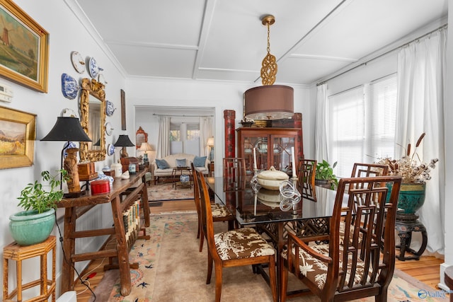 dining area featuring ornamental molding and hardwood / wood-style flooring