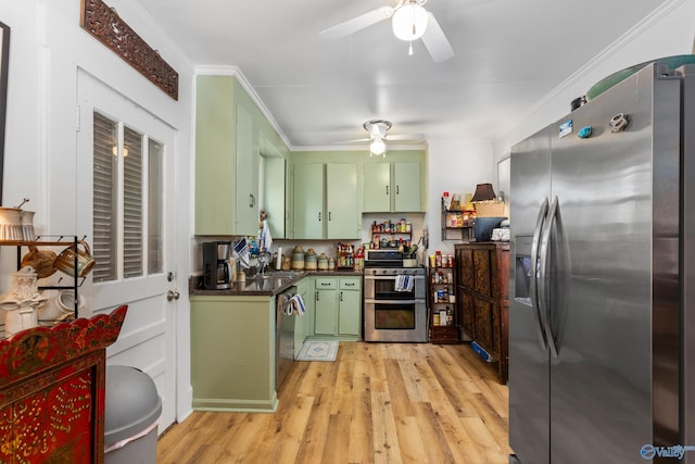 kitchen with light hardwood / wood-style floors, crown molding, appliances with stainless steel finishes, and green cabinetry