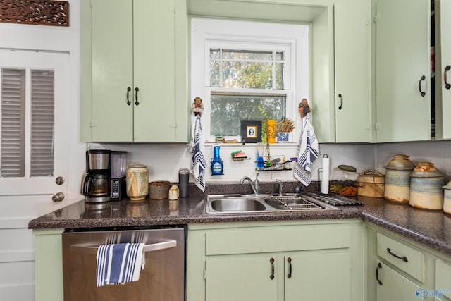 kitchen featuring green cabinets, decorative backsplash, dishwasher, and sink