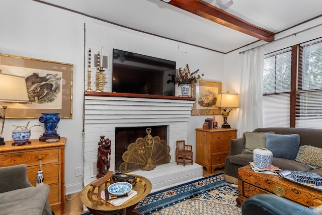 living room featuring beam ceiling, a fireplace, and hardwood / wood-style floors