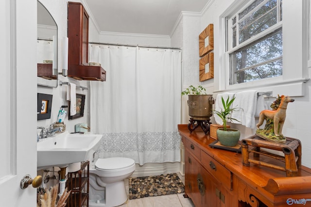 full bathroom featuring sink, toilet, crown molding, and tile patterned floors