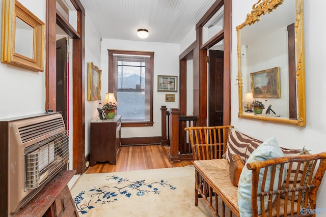 hallway with light hardwood / wood-style floors and heating unit