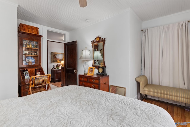 bedroom featuring hardwood / wood-style flooring, ceiling fan, and ornamental molding