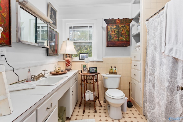 bathroom featuring vanity, toilet, tile walls, and crown molding