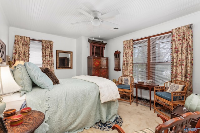 bedroom featuring ceiling fan, light colored carpet, and ornamental molding